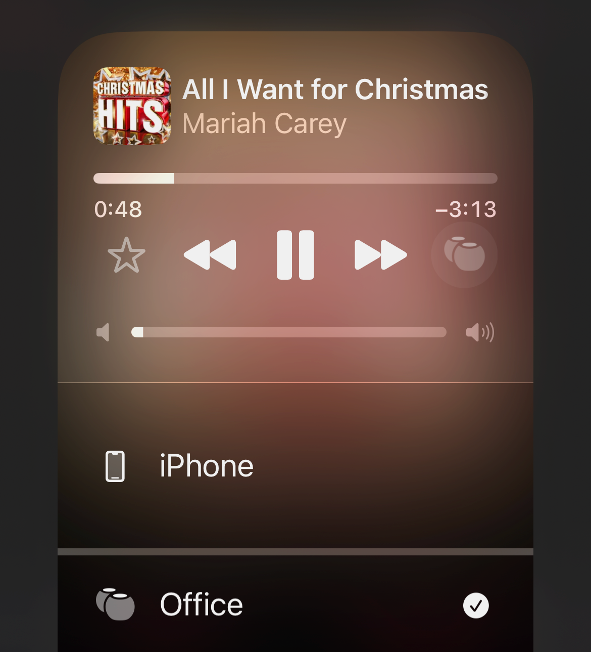 iPhone music controls "All I Want for Christmas Is You" by Mariah Carey playing on the office speakers